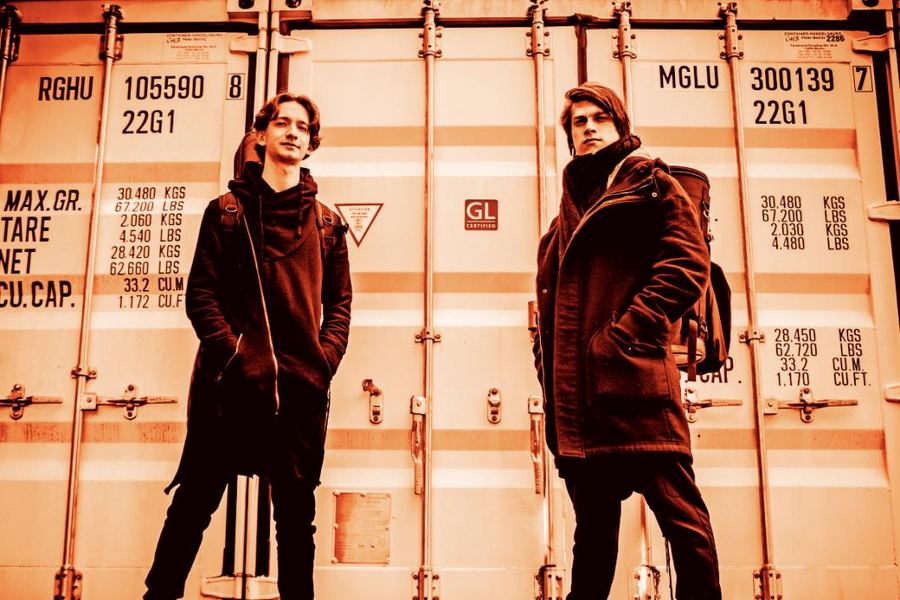 Jure Slapar and Maj Kavšek in front of shipping containers